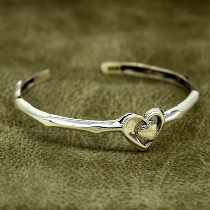 925 sterling silver heart design bangle bracelet by TRIBAL ORNAMENTS, featuring a handmade, adjustable cuff with an elegant heart motif.