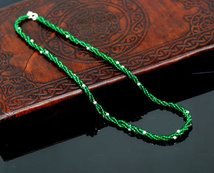 Custom galaxy necklace by TRIBAL ORNAMENTS featuring silver semi-precious green beads on a triple-strand 925 silver design.