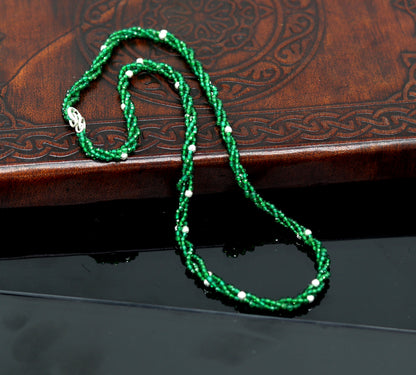 Custom galaxy necklace by TRIBAL ORNAMENTS featuring silver semi-precious green beads on triple silver strands.