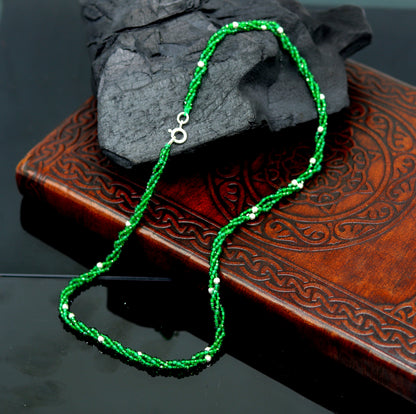 Custom galaxy necklace by TRIBAL ORNAMENTS featuring silver semi-precious green beads on triple silver strands.