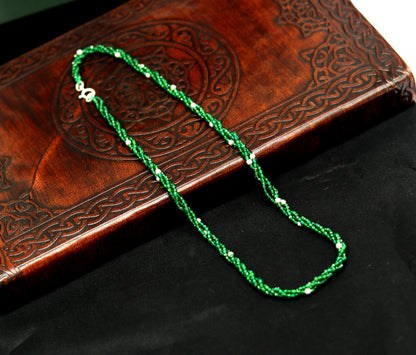 Custom galaxy necklace by TRIBAL ORNAMENTS featuring silver semi-precious green beads on triple silver strands.