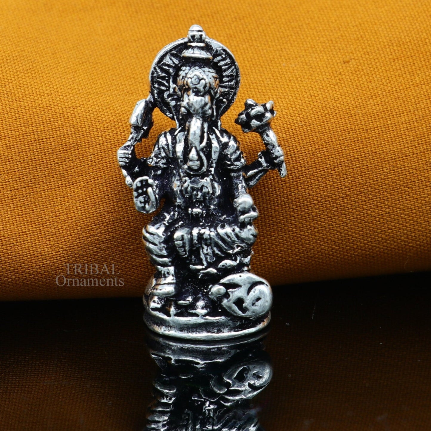 Small Divine Ganesha statue in 925 sterling silver by Tribal Ornaments, ideal for home temple or car puja decor.