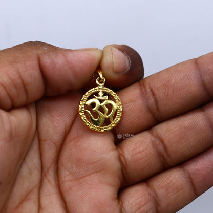 Sterling silver OM 'AUM' pendant by TRIBAL ORNAMENTS, unisex gold-polished jewelry with intricate design and divine symbolism.