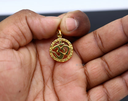 Sterling silver OM AUM pendant by TRIBAL ORNAMENTS, stylish unisex jewelry with gold polished finish and intricate design.