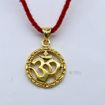 Sterling silver OM AUM pendant by TRIBAL ORNAMENTS, unisex gold-polished jewelry with intricate design and spiritual symbolism.