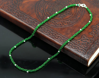 Elegant custom galaxy necklace by TRIBAL ORNAMENTS featuring silver semi-precious green beads and a triple chain design.
