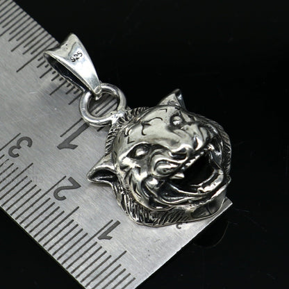 Sterling silver lion face pendant by TRIBAL ORNAMENTS featuring a detailed handmade design, unisex jewelry for gifting.