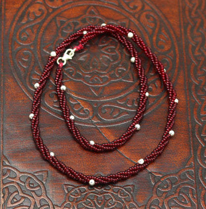 Elegant handmade galaxy necklace by TRIBAL ORNAMENTS featuring silver and semi-precious beads on a triple chain set.