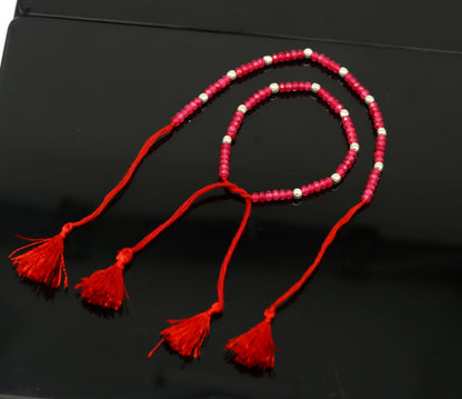Elegant tribal ornaments anklet with semi-precious ruby stones and 925 silver beads, custom-made beaded jewelry for women.
