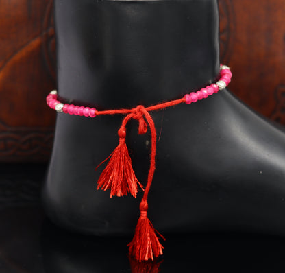 Elegant tribal-style anklets with semi-precious ruby stones and 925 silver beads, designed as a modern beaded ankle bracelet.