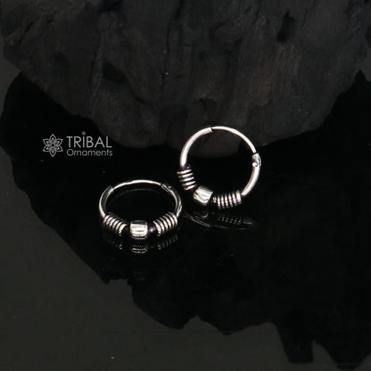 Sterling silver handmade small hoop earrings by Tribal Ornaments, stylish Bali tribal jewelry with intricate design.