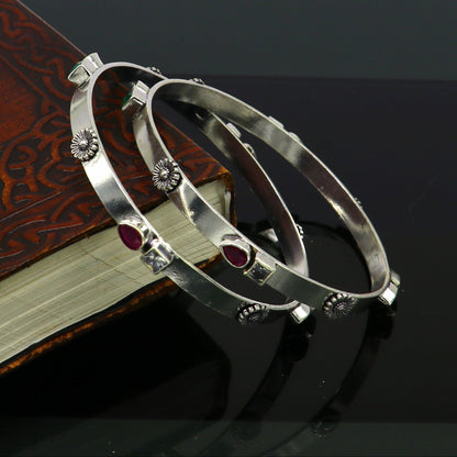 Sterling silver tribal bangles with green and red stones, handmade jewelry by Tribal Ornaments, stylish and unique design.