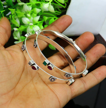 Sterling silver tribal bangle bracelet with green and red stones, handmade traditional jewelry by TRIBAL ORNAMENTS.