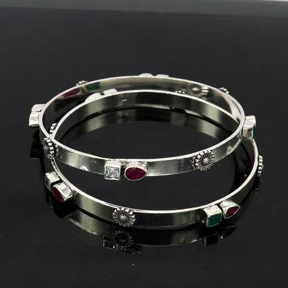 Sterling silver tribal bangles with green and red stones, handmade jewelry by Tribal Ornaments, stylish and unique design.