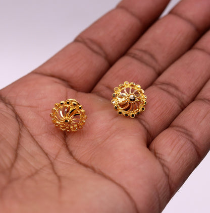 22Kt yellow gold handmade filigree stud earrings by Tribal Ornaments, showcasing intricate Indian ethnic jewelry design.