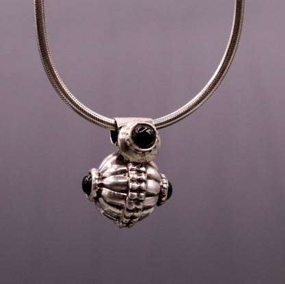 Handmade vintage sterling silver pendant necklace with black stone, tribal jewelry from India, featuring intricate antique design.
