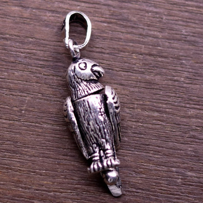Sterling silver parrot-shaped pendant by TRIBAL ORNAMENTS, handmade, unisex jewelry, featuring detailed bird design, perfect gift accessory.