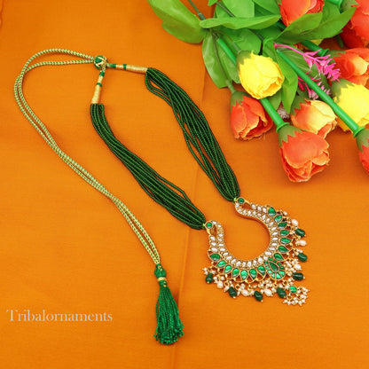 Gold polished sterling silver charm necklace with peacock pendant and hanging pearls, featuring intricate tribal ornament design.