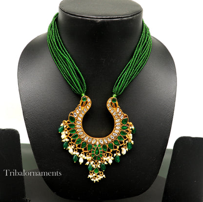 Gold polished sterling silver charm necklace featuring a peacock pendant with hanging pearls, from Tribal Ornaments.