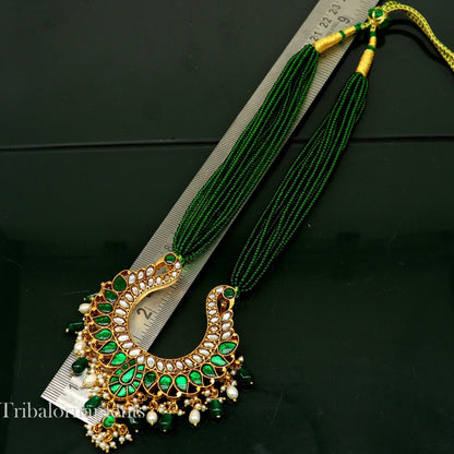 Gold polished sterling silver charm necklace featuring a peacock pendant with hanging pearls, from Tribal Ornaments.
