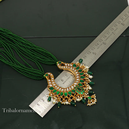 Gold polished sterling silver necklace with a peacock pendant and hanging pearls, featuring a charming tribal-inspired design.