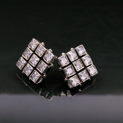 Handmade sterling silver stud earring with cubic zirconia and a pendant, showcasing intricate tribal design and elegant craftsmanship.