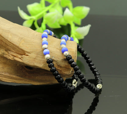 Handmade black beads baby bracelet with evil eye charm, customizable unisex newborn gift baby bangle by Tribal Ornaments.