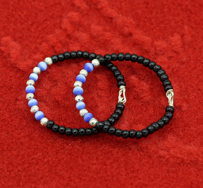 Handmade black beads baby evil eye bracelet by TRIBAL ORNAMENTS, customizable unisex newborn gift baby bracelet.