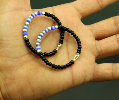 Handmade black beads baby bracelet with evil eye charm, unisex newborn gift, by TRIBAL ORNAMENTS, customized for kids.
