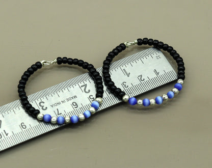 Handmade black beads baby bracelet with evil eye charm, unisex newborn gift, customized tribal ornament for kids.