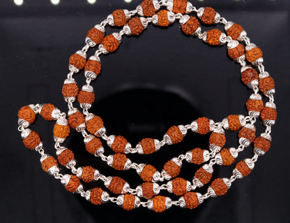 Handmade silver caps with natural rudraksha beads on a unisex silver chain necklace, showcasing tribal-inspired jewelry design.