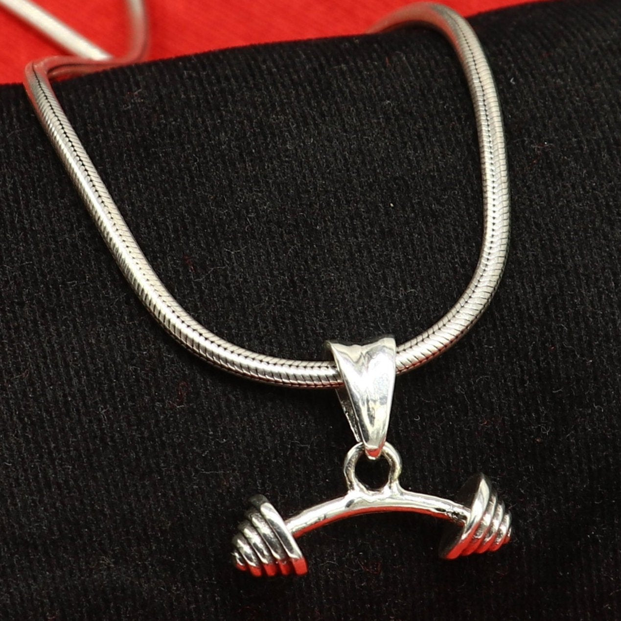 Sterling silver dumbbell pendant by Tribal Ornaments, stylish unisex jewelry with unique handmade design from India.