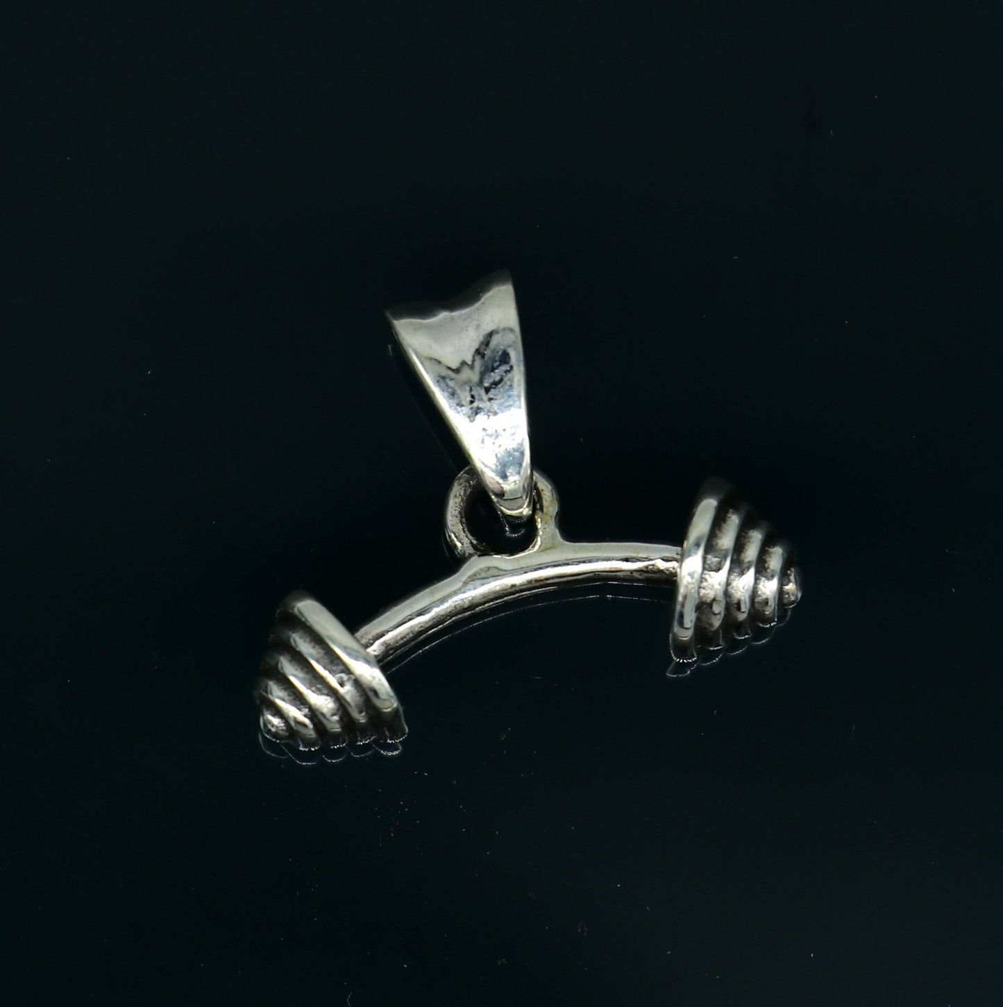 Sterling silver dumbbell pendant from TRIBAL ORNAMENTS, stylish unisex jewelry with unique handmade design in India.