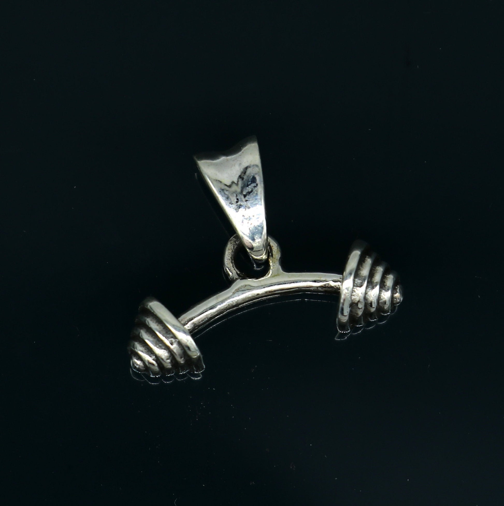 Sterling silver dumbbell pendant from TRIBAL ORNAMENTS, stylish unisex jewelry with unique handmade design in India.