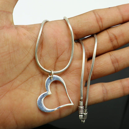 Sterling silver heart pendant by TRIBAL ORNAMENTS, handmade unisex jewelry with a unique, stylish design for personalized gift-giving.