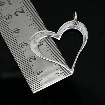 Sterling silver heart pendant by TRIBAL ORNAMENTS, stylish unisex jewelry with handmade design, perfect for personalized gift.