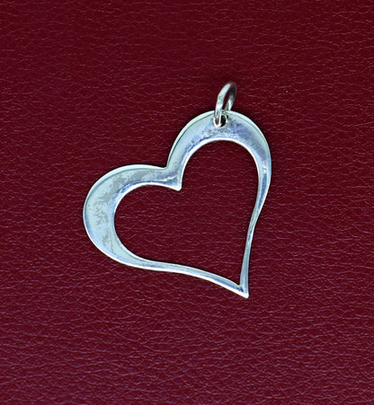 Sterling silver heart pendant by TRIBAL ORNAMENTS, stylish unisex jewelry with a unique handmade design and personalized touch.