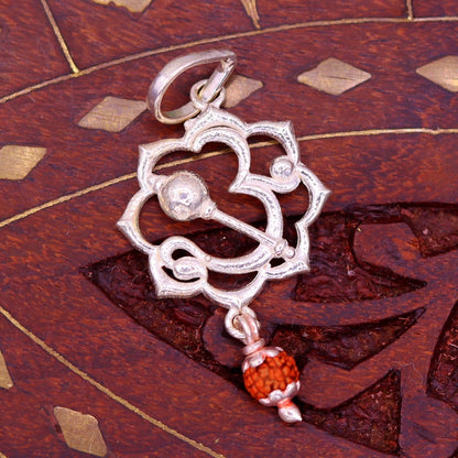 Sterling silver Aum mantra Rudraksha pendant from TRIBAL ORNAMENTS, vintage designer jewelry with intricate detailing.