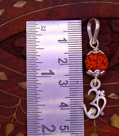 Sterling silver Aum mantra Rudraksha pendant from Tribal Ornaments, vintage designer jewelry with intricate details.