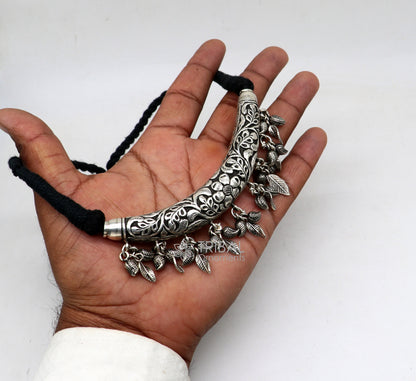 Traditional Indian tribal jewelry set featuring a customized 925 sterling silver Kandrai work charm necklace, hasali, and choker.
