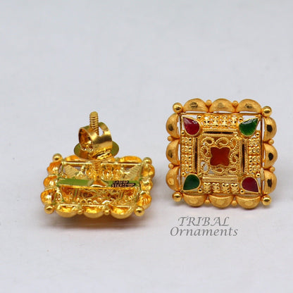 Indian traditional handmade flower design 22K yellow gold stud earrings for women by Tribal Ornaments, with intricate hand-carved detail.
