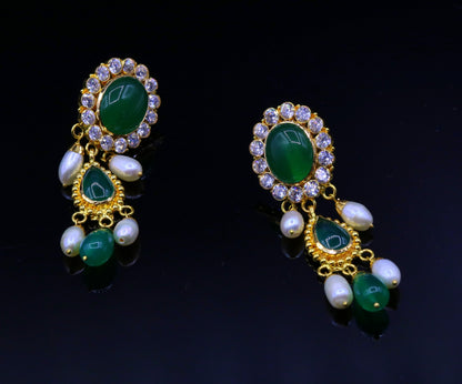 Handmade Indian tribal earrings with green stones and 22k yellow gold, featuring traditional Rajasthan-style dangling jewelry.