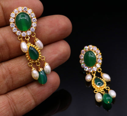 Handmade Indian tribal earrings with green stones and 22k yellow gold in traditional Rajasthan style, featuring dangling design.
