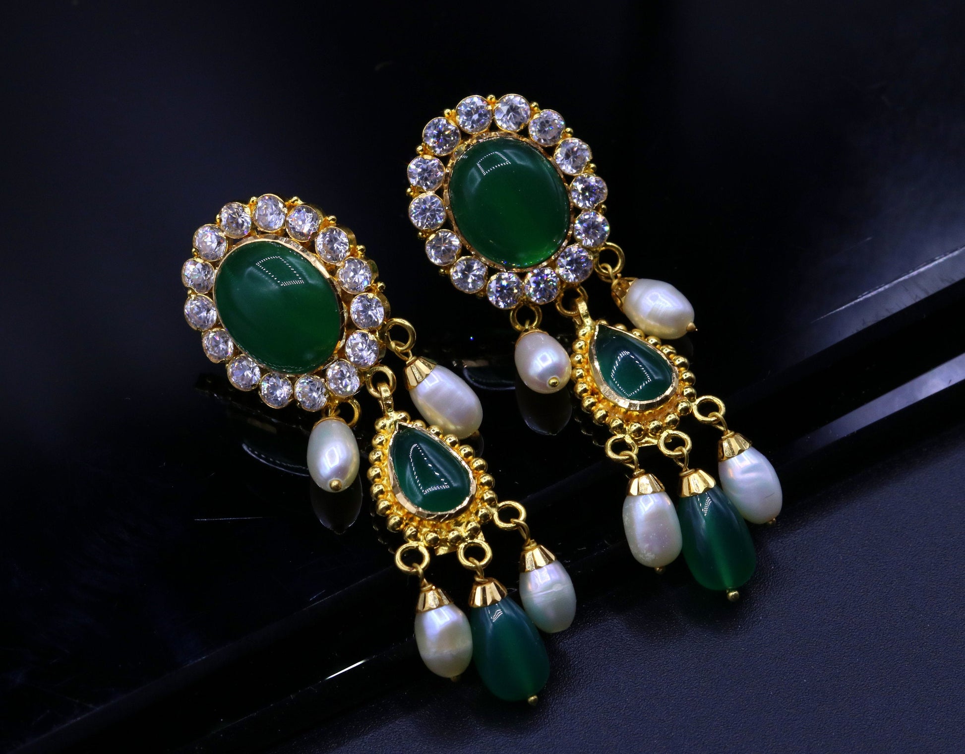 Green stone handmade Indian tribal earrings in 22k yellow gold, featuring traditional dangling design from Rajasthan.