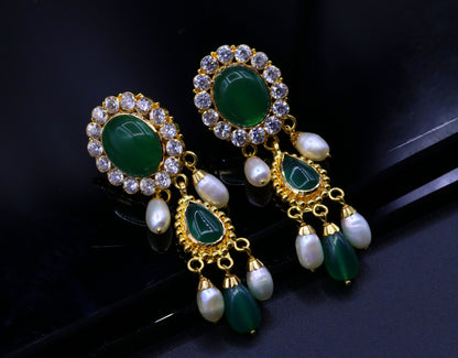 Green stone handmade Indian tribal earrings in 22k yellow gold, featuring traditional dangling design from Rajasthan.