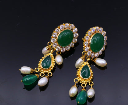 Handmade Indian tribal earrings with green stones, 22k yellow gold, traditional Rajasthan style, dangling tribal jewelry.
