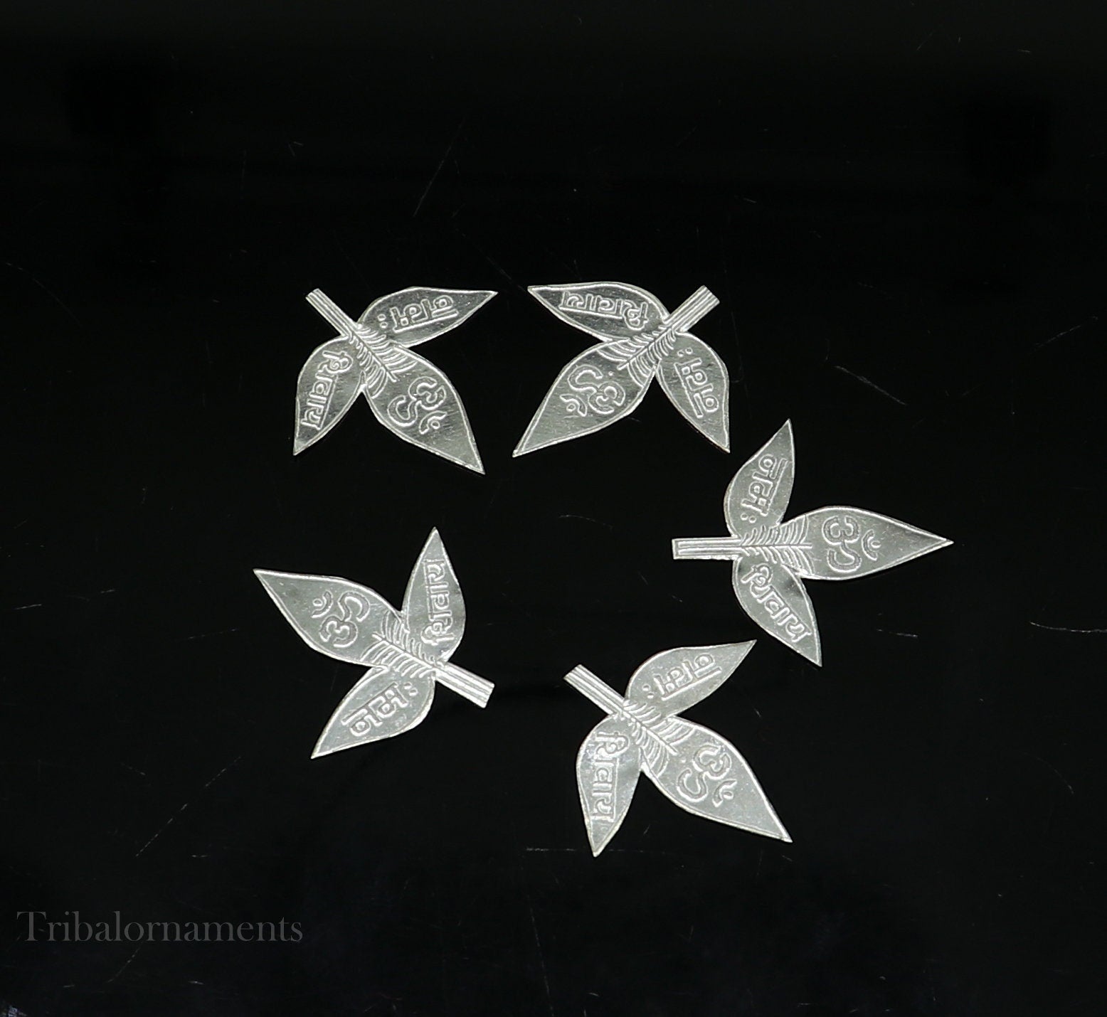 Set of 5 handmade solid silver Belva leaves for Shiva puja, featuring Shiva mantras, crafted by Tribal Ornaments.