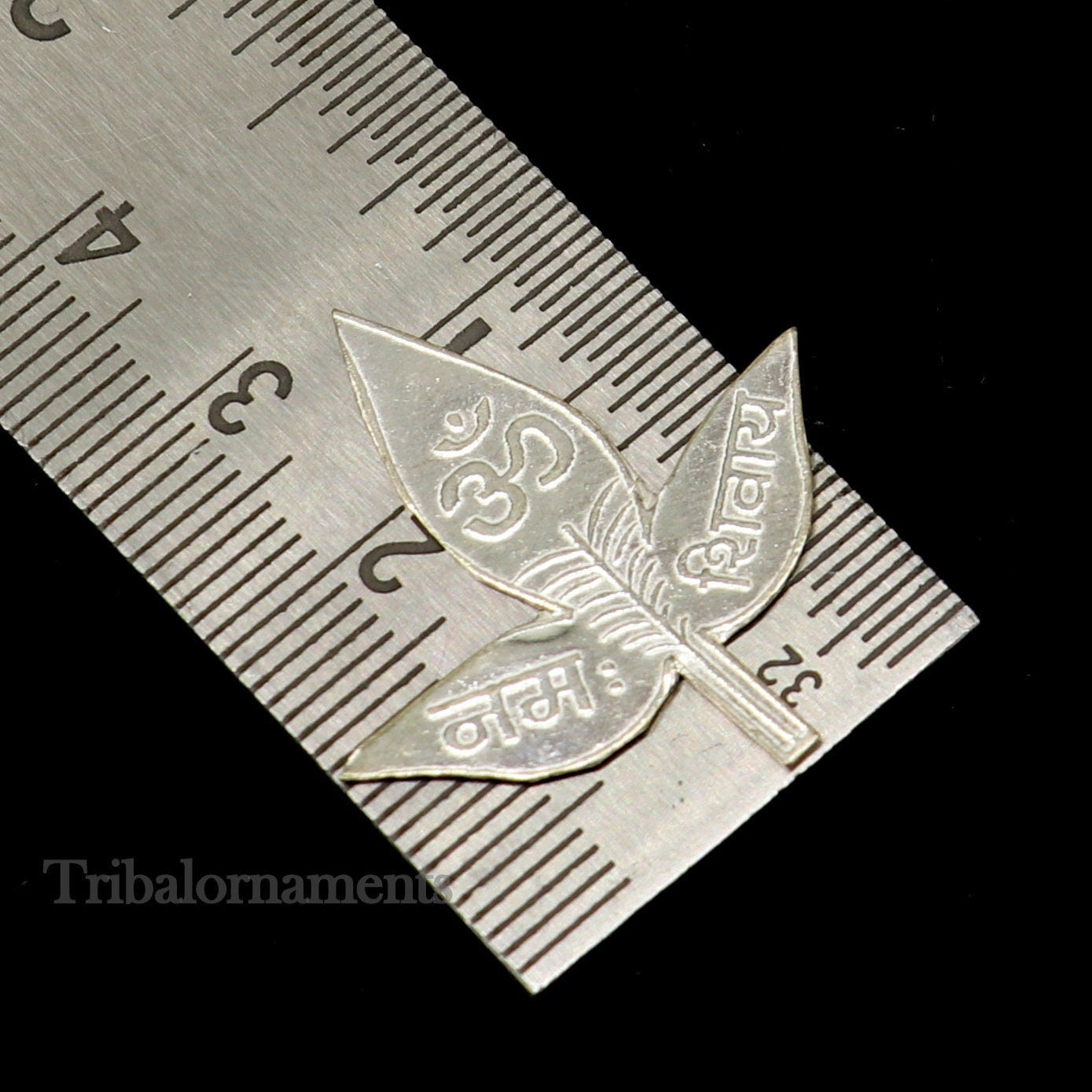 Set of 5 handmade solid silver Belva Patra leaves for Shiva puja, featuring intricate designs and Shiva mantras, by Tribal Ornaments.