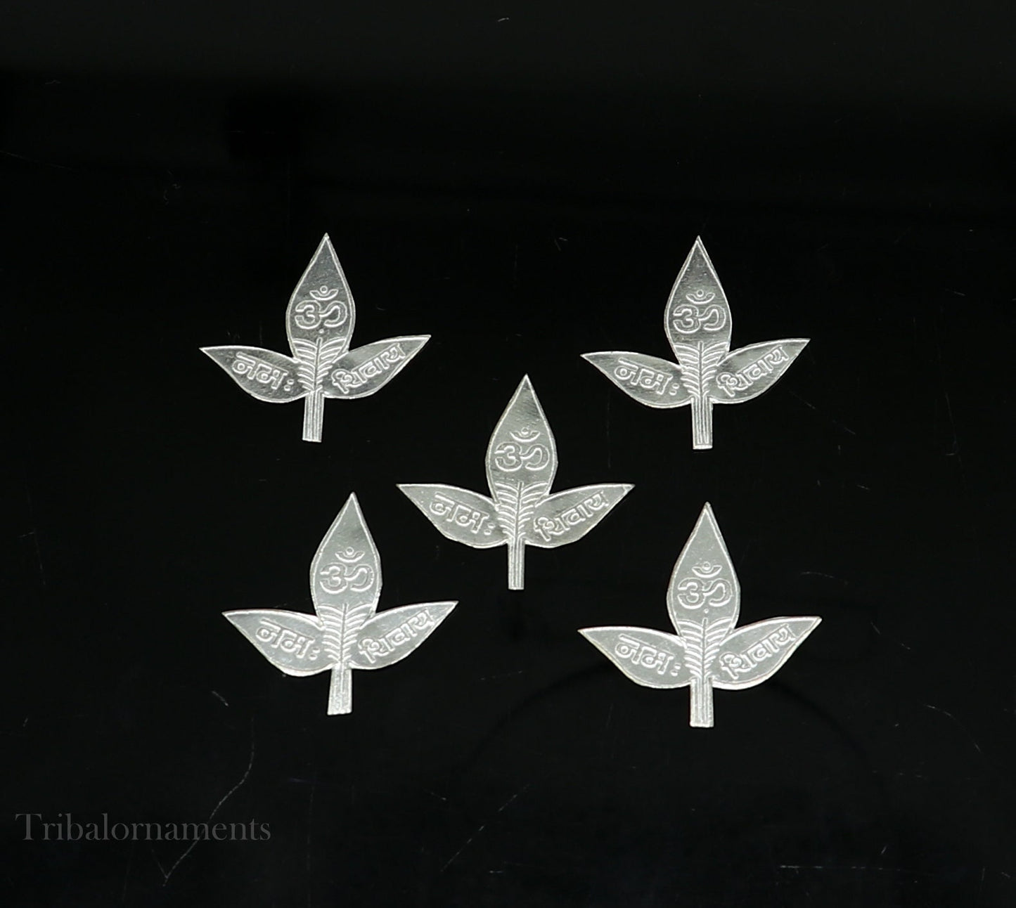 Set of 5 handmade solid silver Belva Patra leaves for Shiva worship, featuring intricate designs and Shiva mantras on each leaf.