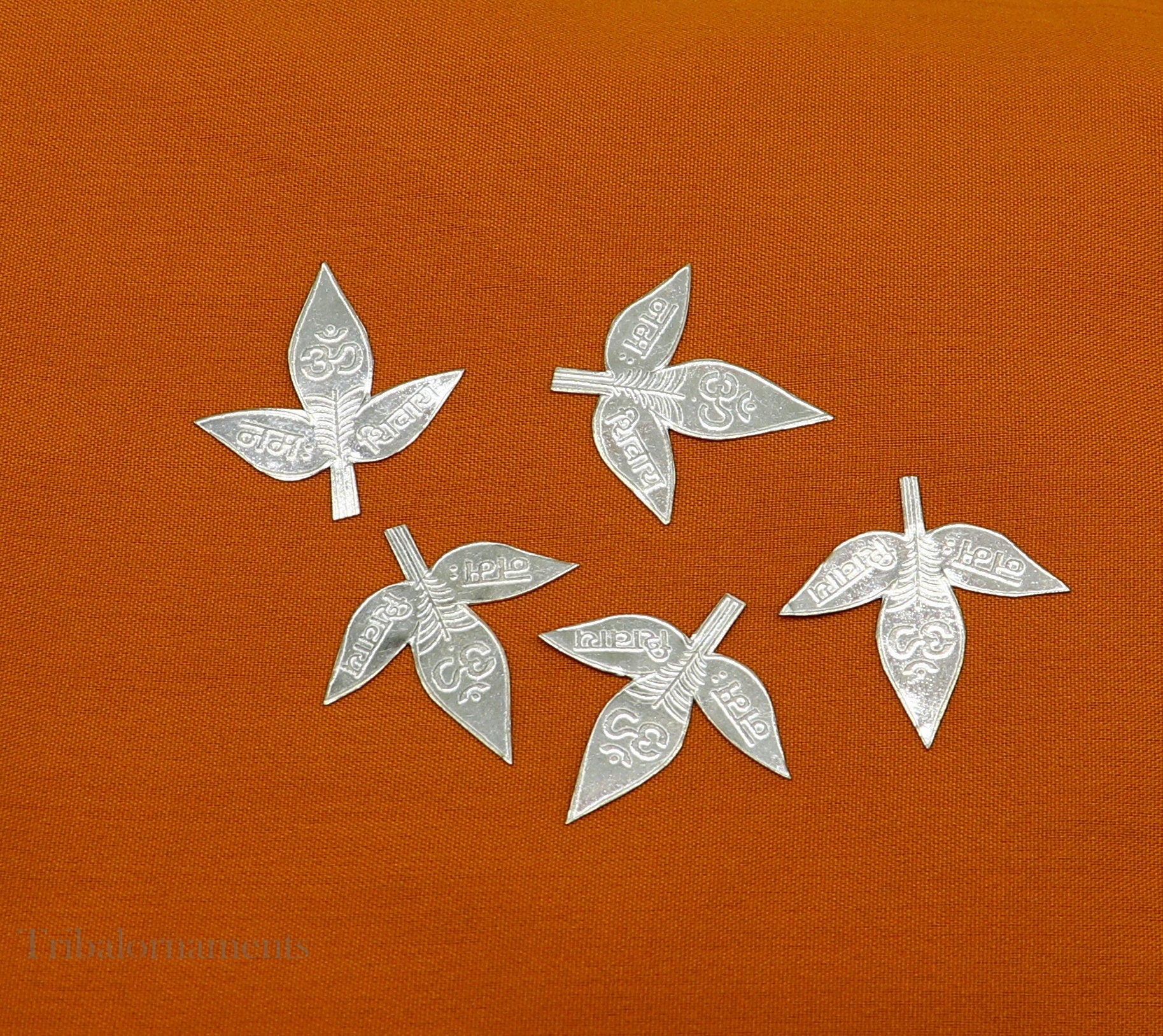 Set of 5 handmade solid silver Belva Patra leaves for Shiva worship, featuring Shiva mantras, crafted by Tribal Ornaments.